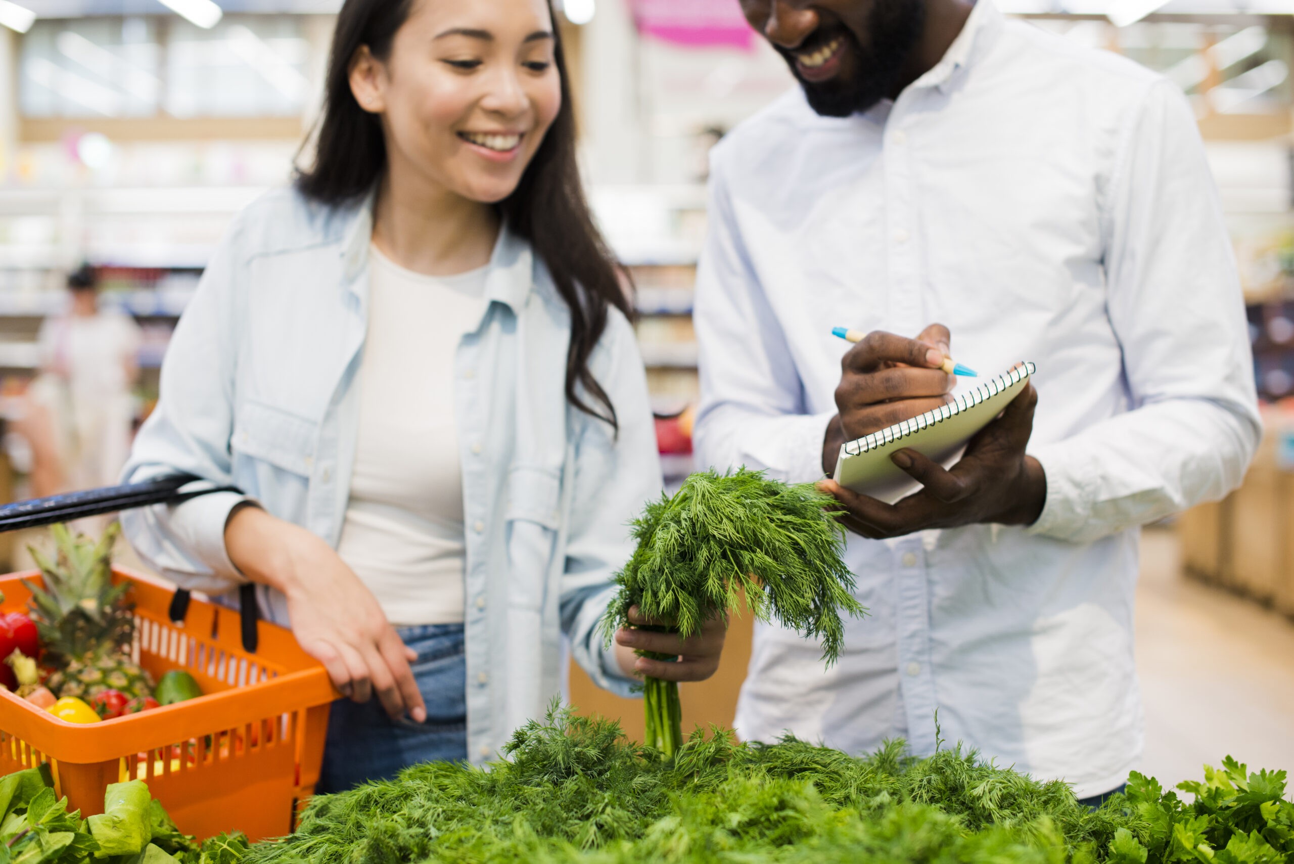 happy-couple-choosing-greenery-grocery-store